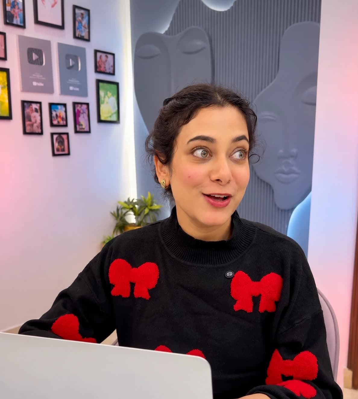 A creator at her desk, mid-conversation